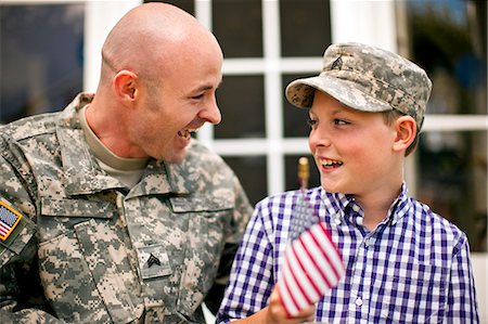 simsearch:6128-08737851,k - Smiling young boy and his father sitting on the porch of their home. Stockbilder - Premium RF Lizenzfrei, Bildnummer: 6128-08737842