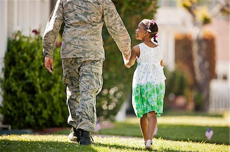 rear view african american girl - Young girl walking hand in hand with her father in their back yard. Stock Photo - Premium Royalty-Free, Code: 6128-08737855