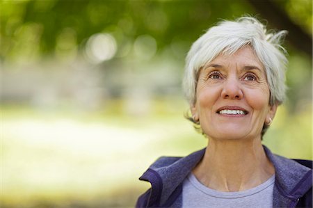 senior woman alone thinking - Happy senior woman smiling. Stock Photo - Premium Royalty-Free, Code: 6128-08737815