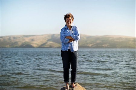 senior woman portrait looking at camera alone full body stand - Portrait of a smiling mature woman. Stock Photo - Premium Royalty-Free, Code: 6128-08737970