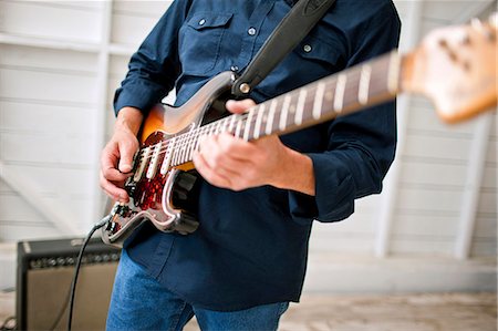 simsearch:6128-08737935,k - Hands of a mid adult man playing an electric guitar. Stock Photo - Premium Royalty-Free, Code: 6128-08737926