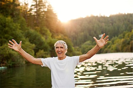 simsearch:841-07201661,k - Portrait of a smiling senior man standing next to a lake while on vacation. Stock Photo - Premium Royalty-Free, Code: 6128-08738080