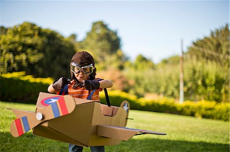 simsearch:649-09139265,k - Young boy having fun pretending to be a pilot in a cardboard plane. Stock Photo - Premium Royalty-Free, Code: 6128-08738003