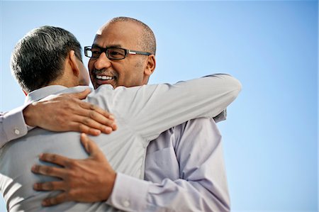 simsearch:6128-08747789,k - Businessmen embracing on balcony. Stock Photo - Premium Royalty-Free, Code: 6128-08738031