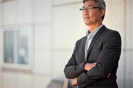 simsearch:6128-08747789,k - Businessman standing on balcony. Stock Photo - Premium Royalty-Free, Code: 6128-08738032