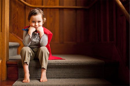 sitting sad boy - Young boy wearing a superhero cape. Stock Photo - Premium Royalty-Free, Code: 6128-08738119