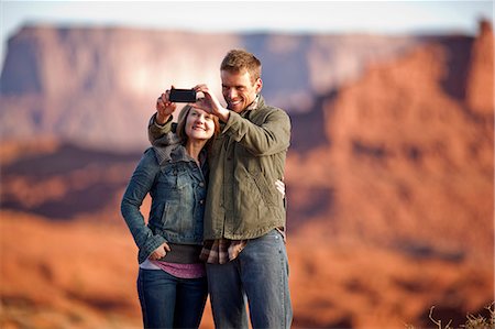 simsearch:6126-09103925,k - Smiling couple taking a self portrait on a cell phone. Stock Photo - Premium Royalty-Free, Code: 6128-08738364