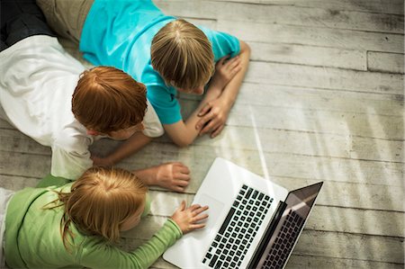 simsearch:6102-07843895,k - Happy siblings playing with a laptop computer. Foto de stock - Sin royalties Premium, Código: 6128-08738373