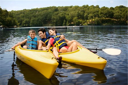 Happy family kayaking on a lake. Stock Photo - Premium Royalty-Free, Code: 6128-08738470