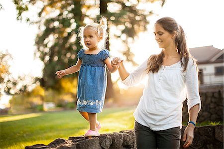 simsearch:400-04795754,k - Happy young girl walking hand in hand with her mother. Stock Photo - Premium Royalty-Free, Code: 6128-08738546