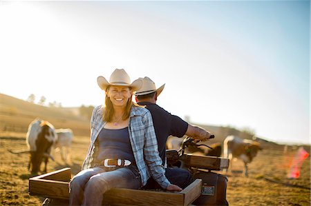 depth of field portrait - Portrait of a woman riding on the back of her husband's quad bike out on the ranch. Stock Photo - Premium Royalty-Free, Code: 6128-08738561