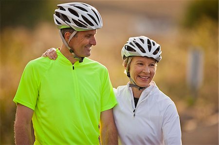 senior couple riding bicycles - Happy mature man smiling at his wife. Stock Photo - Premium Royalty-Free, Code: 6128-08738509