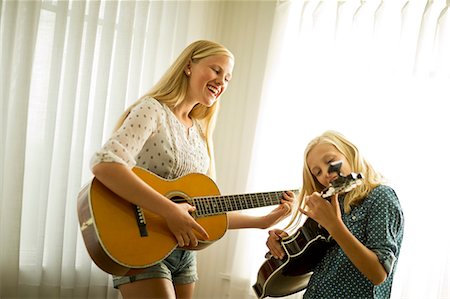 simsearch:6128-08737935,k - Happy teenage girls playing guitar together. Stock Photo - Premium Royalty-Free, Code: 6128-08738519