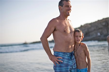 simsearch:6128-08825403,k - Father and son standing together at the beach Stock Photo - Premium Royalty-Free, Code: 6128-08841016