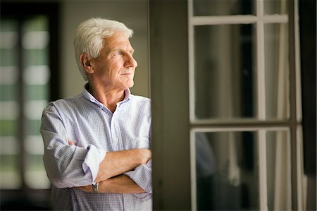 profile of old men - View of a sad man standing at a doorway. Stock Photo - Premium Royalty-Free, Code: 6128-08825354