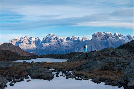 Hiker admire Brenta Dolomites near Black lake. Nembrone Valley, Adamello Brenta park, Trento province, Trentino Alto Adige, Italy, Europe Photographie de stock - Premium Libres de Droits, Code: 6129-09044007