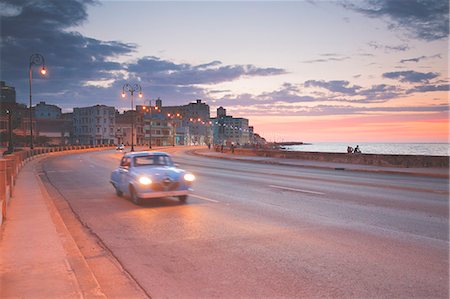 street in sunset with cars - Cuba, Republic of Cuba, Central America, Caribbean Island. Havana City. Stock Photo - Premium Royalty-Free, Code: 6129-09044104