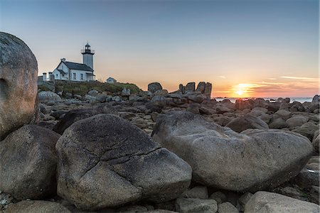 Sunset behind Pontusval lighthouse. Brignogan Plage, Finistère, Brittany, France. Stock Photo - Premium Royalty-Free, Code: 6129-09044399