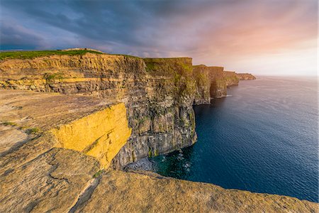 simsearch:6129-09044469,k - Cliffs of Moher (Aillte an Mhothair), Doolin, County Clare, Munster province, Ireland, Europe. Sunset over the cliffs. Foto de stock - Sin royalties Premium, Código: 6129-09044478