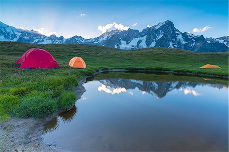 see (der) - Camping tents in the green meadows surrounded by alpine lake at dusk Mont De La Saxe Courmayeur Aosta Valley Italy Europe Stockbilder - Premium RF Lizenzfrei, Bildnummer: 6129-09044856