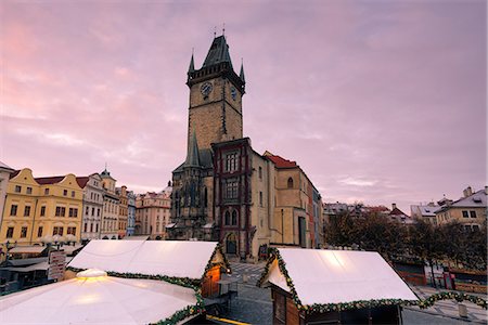 prague christmas - Prague, Czech Republic The clock tower in prague photographed at dawn, in the foreground Christmas stalls Stock Photo - Premium Royalty-Free, Code: 6129-09045046