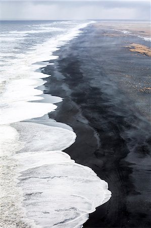 dyrholaey - Aerial view of the long black sand beach of Reynisfjara, Vik, Sudurland, Iceland, Europe Stock Photo - Premium Royalty-Free, Code: 6129-09057691