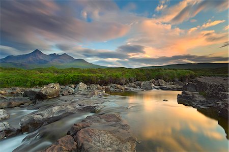 Isle of Skye, Scotland, Europe. The last sunset colors reflected in the water. In the background the peaks of the Black Cuillin. Stock Photo - Premium Royalty-Free, Code: 6129-09058058