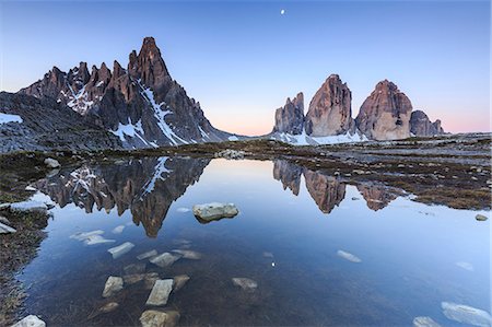 sunrise in the alps - Dawn illuminates the Three Peaks and Mount Paterno reflected in the lake. Sesto Dolomites Trentino Alto Adige Italy Europe Stock Photo - Premium Royalty-Free, Code: 6129-09058147