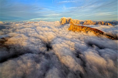 Aerial shot from Seceda of Odle surrounded by clouds at sunset. Dolomites Val Funes Trentino Alto Adige South Tyrol Italy Europe Stock Photo - Premium Royalty-Free, Code: 6129-09058138
