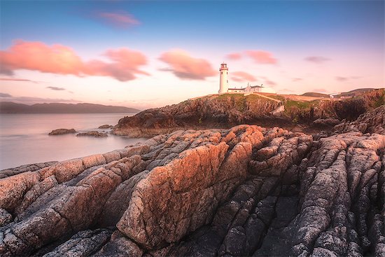 Fanad Head (Fánaid) lighthouse, County Donegal, Ulster region, Ireland, Europe. Pink sunset at Fanad Head Stock Photo - Premium Royalty-Free, Image code: 6129-09086703