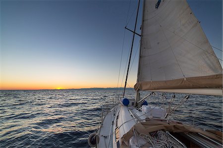 sailboat sunset - Sailing during the sunset (Ligurian Sea, Mediterranean Sea, Italy, Europe) Stock Photo - Premium Royalty-Free, Code: 6129-09086806