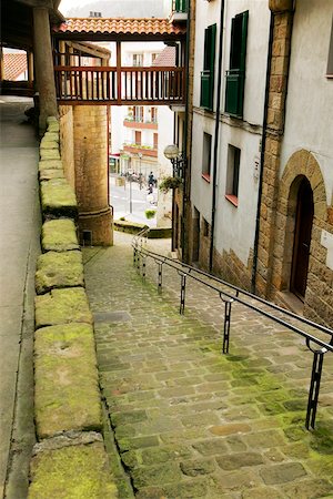 empty street wall - High angle view of an empty alleyway leading to the street, Spain Stock Photo - Premium Royalty-Free, Code: 625-00804501