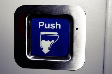 Close-up of a flush button in airplane bathroom Stock Photo - Premium Royalty-Free, Code: 625-00805744