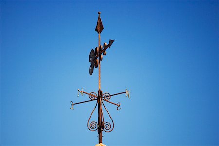 Low angle view of a weather vane on a rooftop Stock Photo - Premium Royalty-Free, Code: 625-00801417