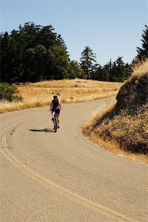 simsearch:625-01095436,k - Rear view of a person cycling Stock Photo - Premium Royalty-Free, Code: 625-00801496