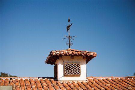 Low angle view of a weather vane on a rooftop Stock Photo - Premium Royalty-Free, Code: 625-00802018