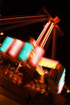 Lights glowing on a carnival ride at night, California, USA Stock Photo - Premium Royalty-Free, Code: 625-00802041