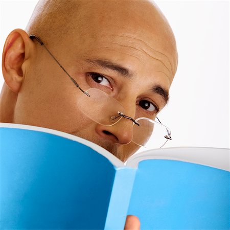 Man wearing glasses and holding report, close-up Stock Photo - Premium Royalty-Free, Code: 625-00802302