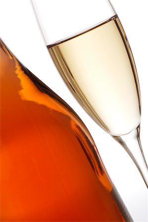 picture of champagne bottle and champagne flute - Close-up of a glass of wine with a wine bottle Stock Photo - Premium Royalty-Free, Code: 625-00802405