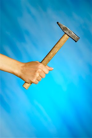Close-up of a woman's hand holding a hammer Stock Photo - Premium Royalty-Free, Code: 625-00802518