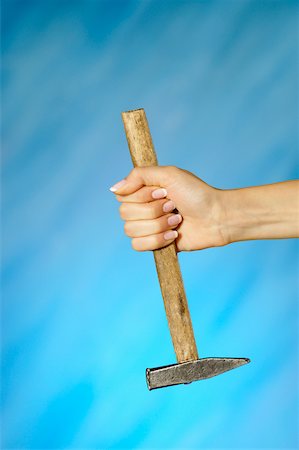 Close-up of a woman's hand holding a hammer Stock Photo - Premium Royalty-Free, Code: 625-00802705