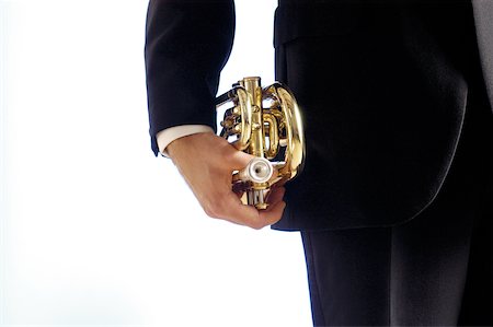 Mid section view of a musician holding a trumpet Stock Photo - Premium Royalty-Free, Code: 625-00802711