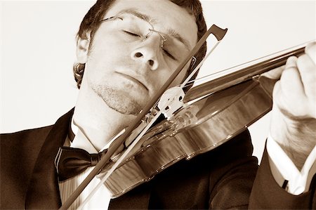 simsearch:625-00802645,k - Close-up of a musician playing the violin Fotografie stock - Premium Royalty-Free, Codice: 625-00802750