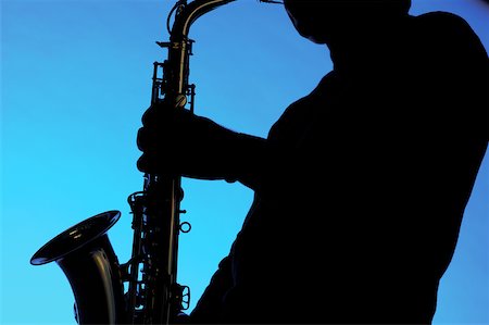 simsearch:625-00802645,k - Silhouette of a musician playing the saxophone Fotografie stock - Premium Royalty-Free, Codice: 625-00802801