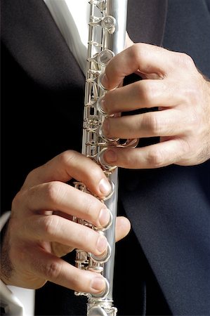 simsearch:625-00802645,k - Mid section view of a musician playing the flute Fotografie stock - Premium Royalty-Free, Codice: 625-00802847