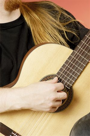 simsearch:625-00802645,k - Mid section view of a musician playing an acoustic guitar Fotografie stock - Premium Royalty-Free, Codice: 625-00802854