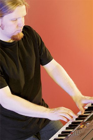 Close-up of a musician playing the synthesizer Stock Photo - Premium Royalty-Free, Code: 625-00802886