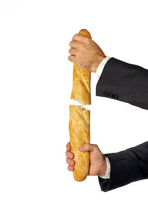 Close-up of a businessman breaking a loaf of bread Foto de stock - Sin royalties Premium, Código: 625-00802930