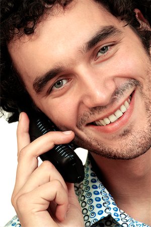 simsearch:625-00850090,k - Portrait d'un jeune homme parlant sur un téléphone mobile Photographie de stock - Premium Libres de Droits, Code: 625-00836333