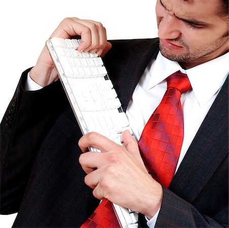 Close-up of a businessman holding a computer keyboard in frustration Stock Photo - Premium Royalty-Free, Code: 625-00836340